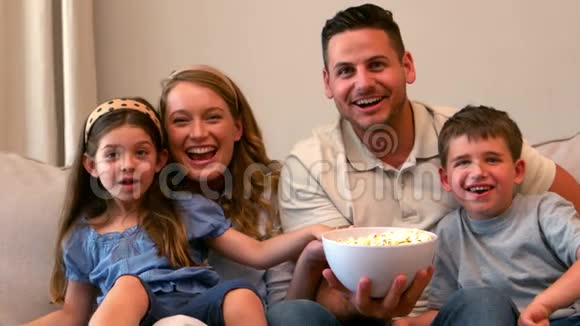 幸福的家人看电视吃爆米花视频的预览图