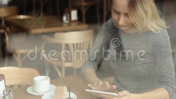 咖啡馆里有平板电脑的快乐女人视频的预览图
