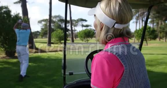 快乐的女高尔夫球手坐在高尔夫球车上视频的预览图