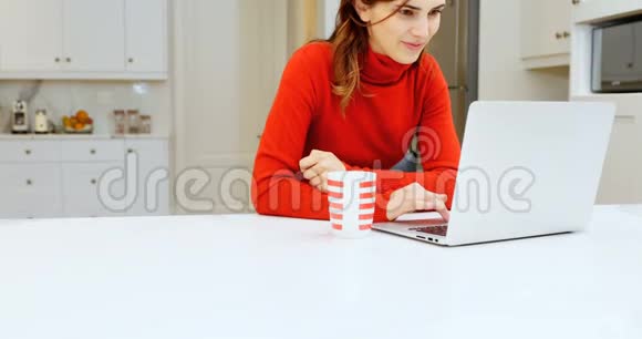 厨房里用笔记本电脑的女人视频的预览图