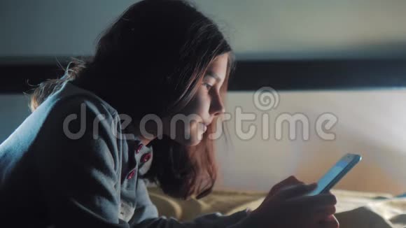 少女和智能手机小青少年帽女孩写生活方式的信息聊天在社交媒体信使之夜视频的预览图