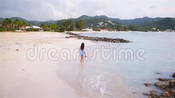 在海滩上散步的年轻美女视频的预览图
