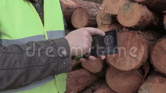 伐木工人靠近森林里的原木视频的预览图