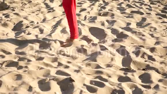一个年轻快乐的家伙跳着现代芭蕾在海边的沙滩上打盹缓行视频的预览图