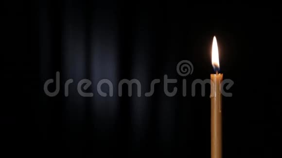 白色光束在黑色背景上燃烧的瘦蜡烛视频的预览图