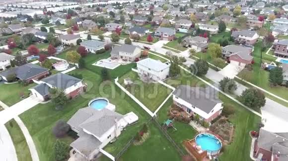 沿着郊区的街道飞过住宅和庭院视频的预览图