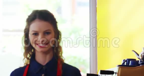 站在柜台前微笑的女服务员的画像视频的预览图