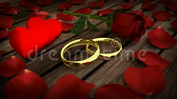 两枚金色结婚戒指和花瓣红色玫瑰视频的预览图