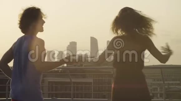 年轻夫妇在日落时跳舞的剪影视频的预览图