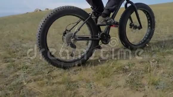 夏天骑着肥肥的自行车或肥肥的自行车穿过山丘视频的预览图