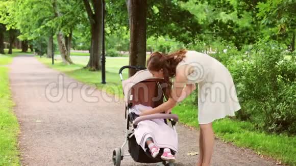 妈妈带着小女孩在夏天公园散步视频的预览图