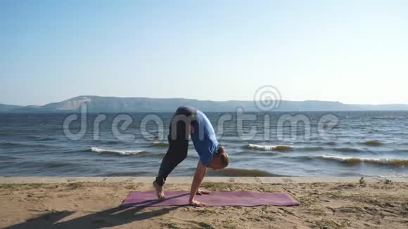 在海岸做瑜伽运动的瑜伽男视频的预览图