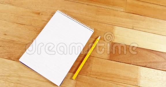 记事本和铅笔放在木板上视频的预览图
