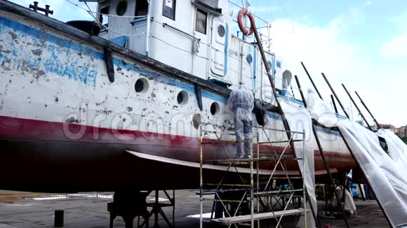 造船厂的工人在修理过程中把金属上的油漆撕掉视频的预览图