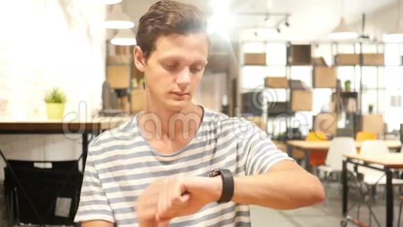 年轻人使用智能手表的肖像视频的预览图