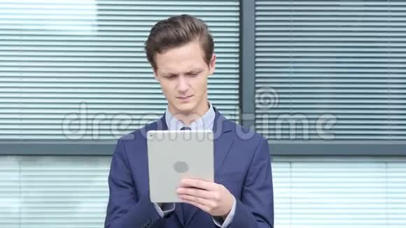 年轻商人使用平板电脑户外视频的预览图