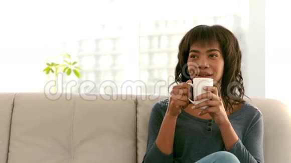 在沙发上喝咖啡的女人视频的预览图