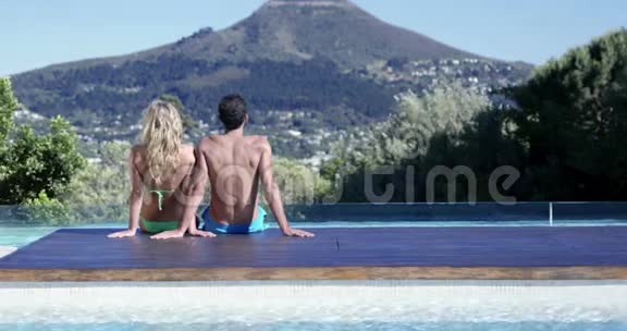 迷人的情侣在泳池边放松视频的预览图