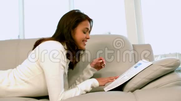 女人在沙发上看报纸视频的预览图