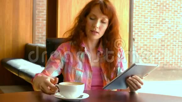 轻松的女人使用她的平板电脑视频的预览图