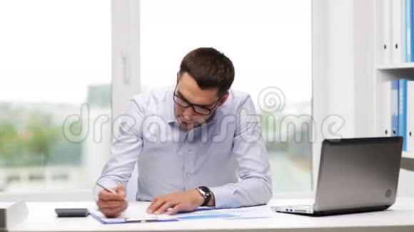 忙碌的商人手提电脑和办公室里的文件视频的预览图