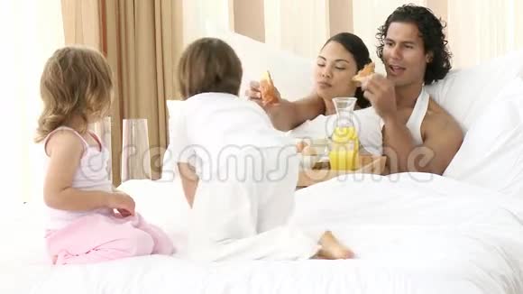 幸福的家庭在卧室吃早餐视频的预览图