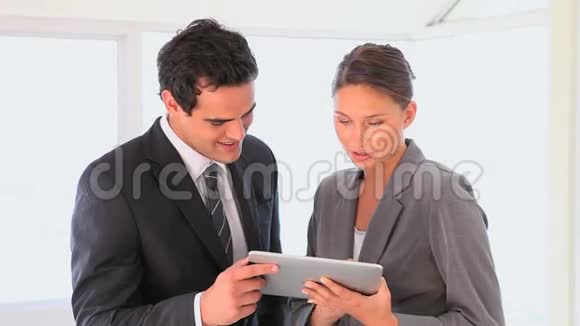 商业男女看平板电脑视频的预览图