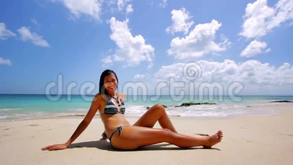 异国海滩日光浴和日光浴的亚洲女孩视频的预览图