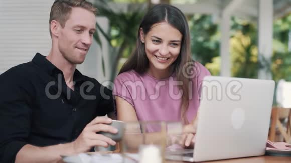 年轻人和女人在时尚的咖啡馆用笔记本电脑工作男人喝咖啡视频的预览图
