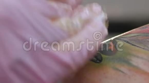 刺青机在女孩的皮肤上注入一种白色的墨水视频的预览图