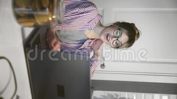 垂直视频的年轻快乐女人通过电话会议交流说话看电脑在厨房视频的预览图