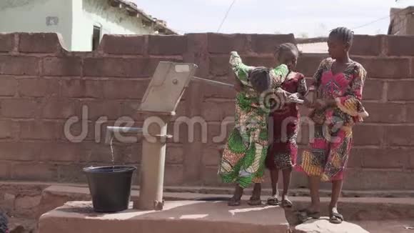 三个非洲小女孩在村子的水井里取水视频的预览图