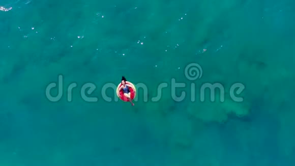 一个女人漂浮在海上的橡胶圈上视频的预览图