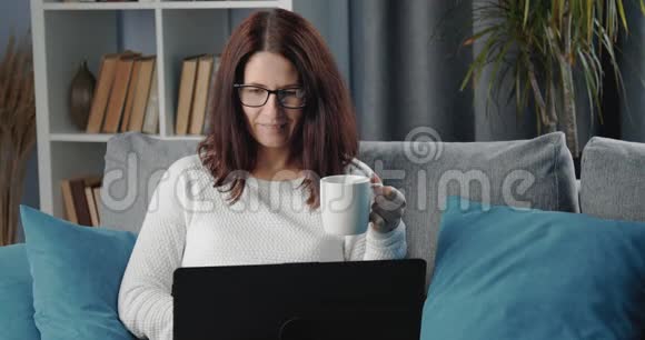 在家中远程使用笔记本电脑的女人视频的预览图