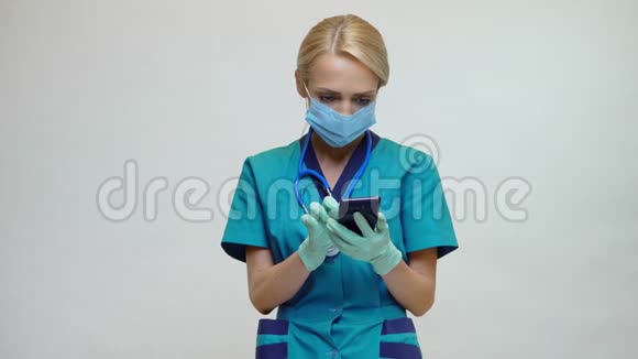 戴防护面罩和乳胶手套的女医生打电话视频的预览图