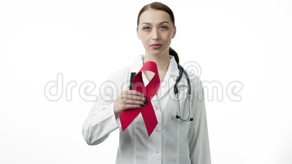 微笑美丽的医生在白色背景上显示艾滋病病毒红色丝带视频的预览图