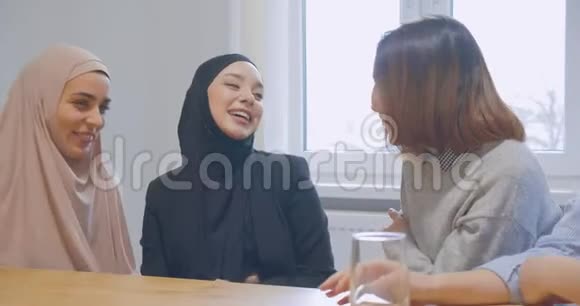 三位办公室通信中断的同事使用智能手机多种多样快乐的笑话hijab亚洲视频的预览图
