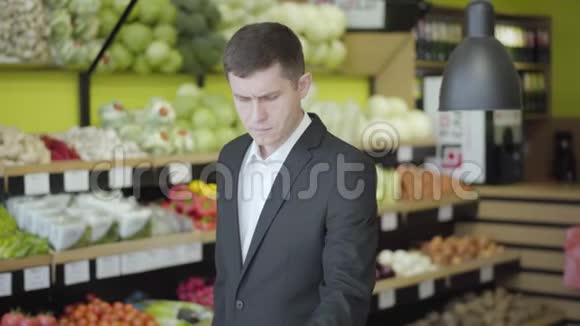 中年白人在杂货店里选择柚子年轻自信的男人买健康的画像视频的预览图