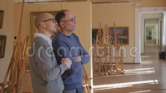 两个人在美术馆里看着画谈论艺术视频的预览图