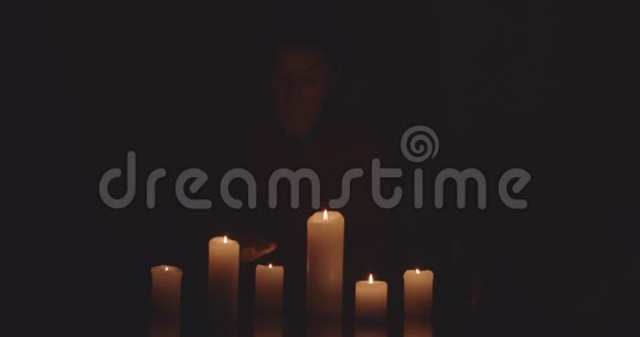 女人在黑暗中点燃蜡烛视频的预览图