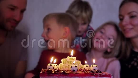 一个家庭圈子里的孩子在他生日那天拿出足球蜡烛视频的预览图