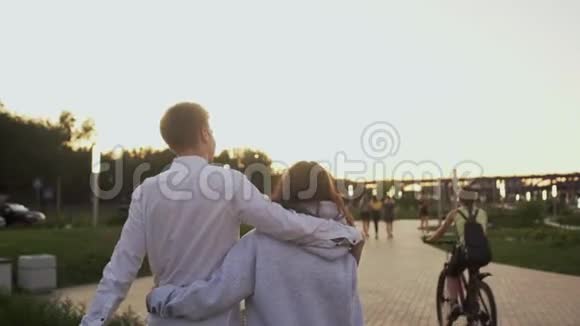 傍晚在夏季公园里年轻可爱的情侣约会后景视频的预览图