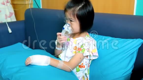 可爱的亚洲孩子拿着一个面罩蒸气吸入器治疗哮喘视频的预览图
