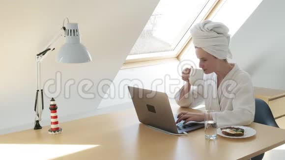 自由职业者穿白色浴袍头上有毛巾呆在家里检疫概念视频的预览图