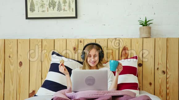 带耳机和笔记本电脑的年轻女性视频的预览图