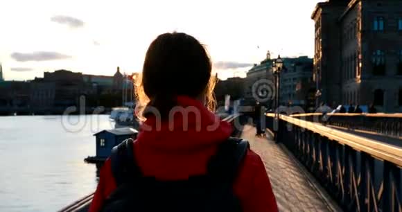 瑞典斯德哥尔摩年轻的高加索女游客行走在著名的斯凯普斯霍尔姆斯布伦斯凯普斯霍尔姆大桥上视频的预览图