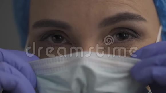 护士戴上医疗面罩看着摄像机视频的预览图