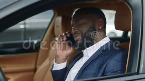 特写非洲男人在车上用电话一名非洲男子在车上移动通话视频的预览图
