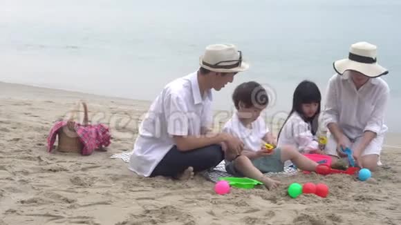 快乐的亚洲家庭在夏天的海滩上玩耍有乐趣父母和孩子休闲享受视频的预览图