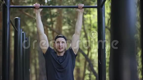 成年白种人强壮的运动员在公园里的健身房里做一个拉力运动视频的预览图